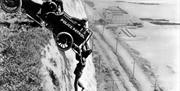 When Stunts go wrong - man holding onto a car, hanging off a cliff