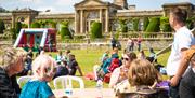 People sat outside enjoying a festival