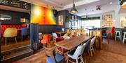 Tables and chairs inside The Cork