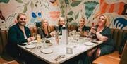 Table of five sat in a booth at The Granary