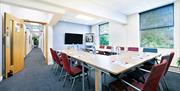 Small meeting room set up in U-shaped seating.
