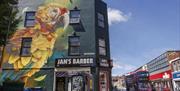 Mural of parrot on shop in East Street, Bedminster.