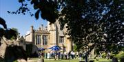Exterior of Farleigh House, people gathered in the Garden