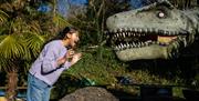 Child shouting at dinosaur animatronic - Caves Bristol and Bath