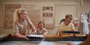Children making paper at Wookey Hole - Caves near Bath and Bristol