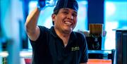 Chef at Yakinori raising a glass in celebration.