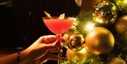 Hand holding festive cocktail