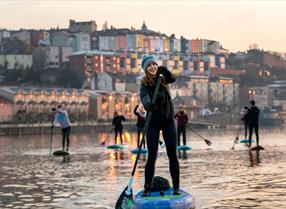 Visit West Thumbnail - Woman Stand Up Paddleboarding in Bristol Harbour - SUP Bristol - CREDIT Paul Box