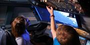 children in aircraft simulator