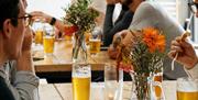 People sat at tables with beers