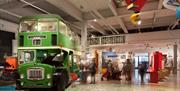 Interior of M Shed with green bus and exhibits