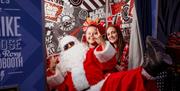 Santa and people in photo booth